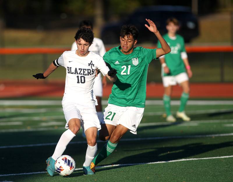 Addison Trail’s Matias Aguilar (10) and York’s Joe Hernandez (21) go after the ball during a Class 3A St. Charles East Sectional semifinal game on Wednesday, Oct. 26, 2022.