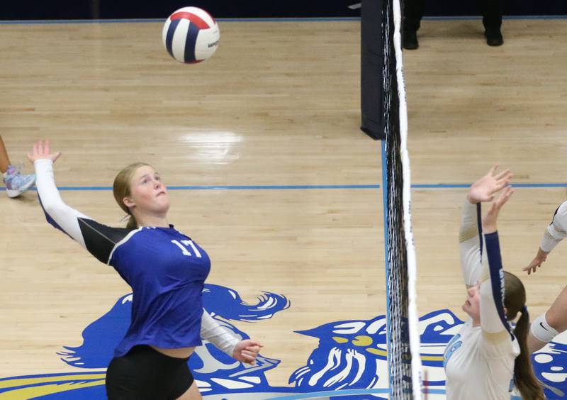 Newark's Zoey Carlson sends a kill past Marquette's Kelsey Cuchra and Kaitlyn Davis on Wednesday, Aug. 27, 2025 in Bader Gymnasium.