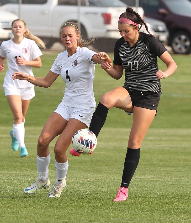 Sycamore's Hailey Clawson kicks the ball away from Prairie Ridge's Emily Gorton during their game Wednesday, May 17, 2023, at Sycamore High School.
