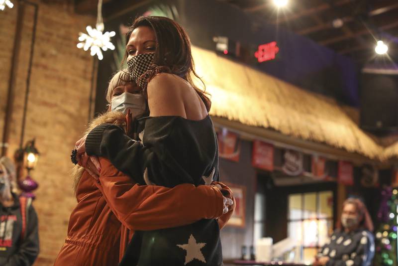 Jamie Littell (right), owner of Moe Joe's, hugs her former employee Jen Laino (left) on Jan. 6, 2021, at Moe Joe's in Plainfield, Ill. Littell and her team prepared holiday meals for over 72 nurses who work in the COVID unit at Edward Hospital in Naperville, Ill. Her staff and volunteers then delivered each meal to thank them for their work.