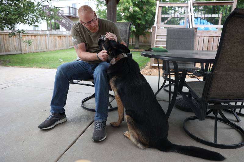 Dan Miller, with the Wounded Warriors Project and K9s for Veterans, spends time with his service dog Rocky in his back yard on Wednesday, July 24, 2024 in Joliet.