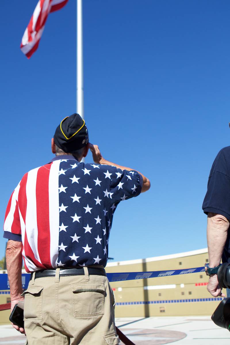 Veteran salutes the flag as it is raised at the Flag Day Monument opening ceremony's at Patriot's Park on Sunday, Oct 1,2023 in Batavia.
