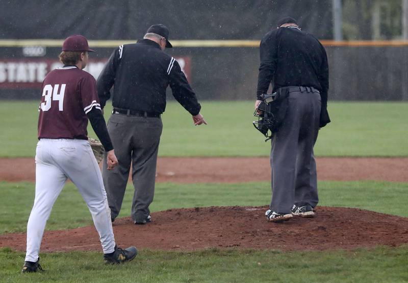 The umpires check the condition of the pitching mound between innings during a Fox Valley Conference baseball game \between Huntley and Prairie Ridge on Friday, May 1, 2026, at Prairie Ridge High School.