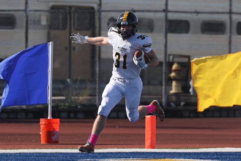 Joliet West’s Christian Sticklen celebrates a touchdown after a fumble recovery against Joliet Central on Saturday.