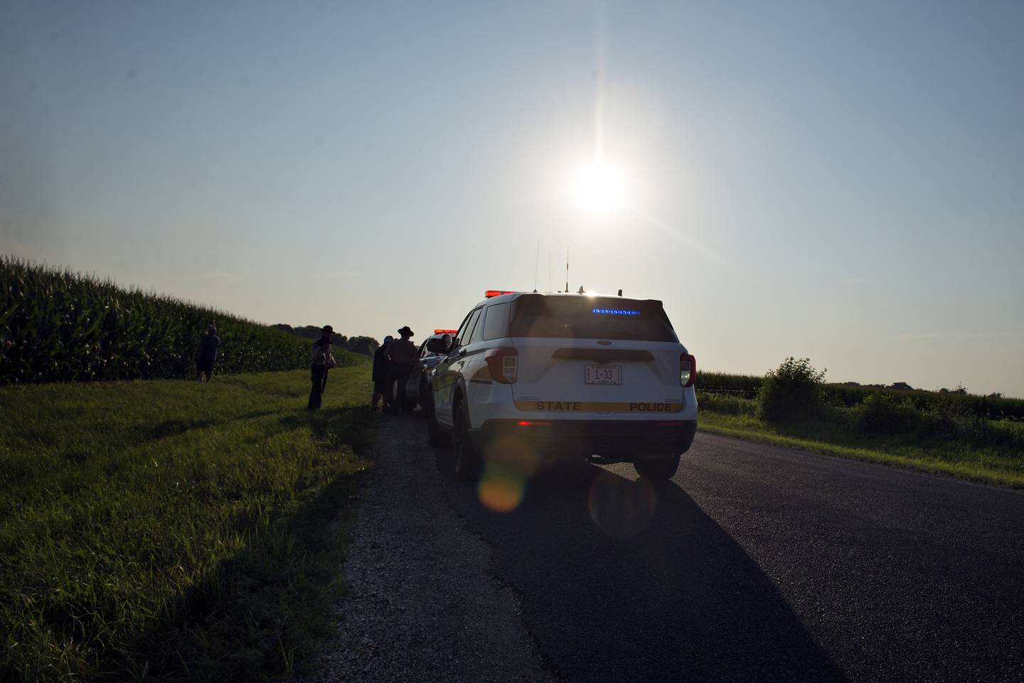 Illinois State Police officers work at the scene of a downed plane off of Thome Road in Rock Falls. There were no injuries from the landing in the cornfield.