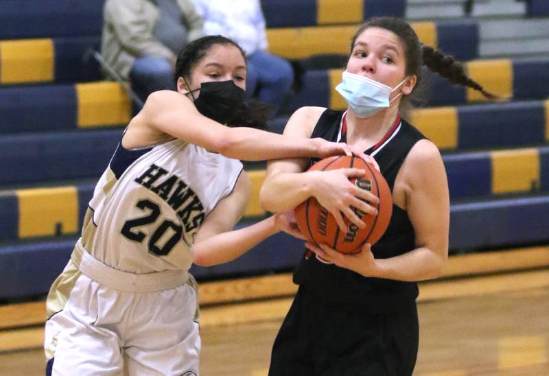 Indian Creek's Alexa Anderson and Hiawatha's Olivea Rotstein fight for a loose ball during their game Thursday, Jan. 27, 2022, at Hiawatha High School in Kirkland.