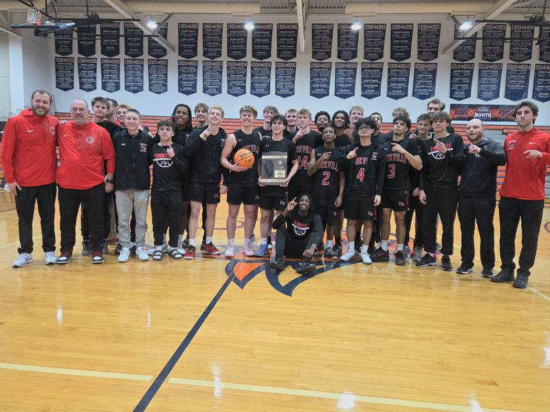 Yorkville poses with the Class 4A Naperville North Regional final basketball Championship game plaque after defeating Downers Grove South, Feb 27, 2026 in Naperville.
