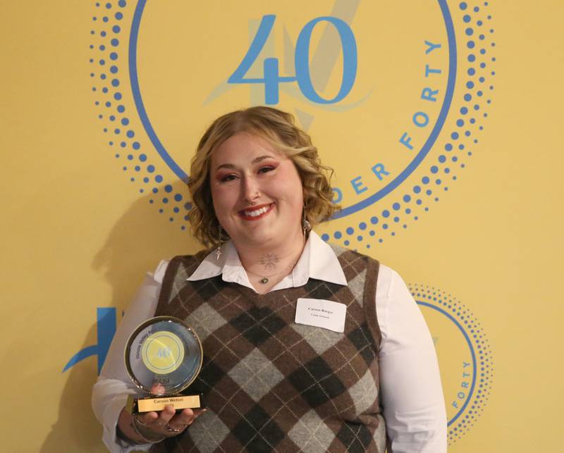 Carson Barger poses for a photo with her award during the 40 Under Forty awards banquet on Thursday, March 21, 2024 at Westclox in Peru.