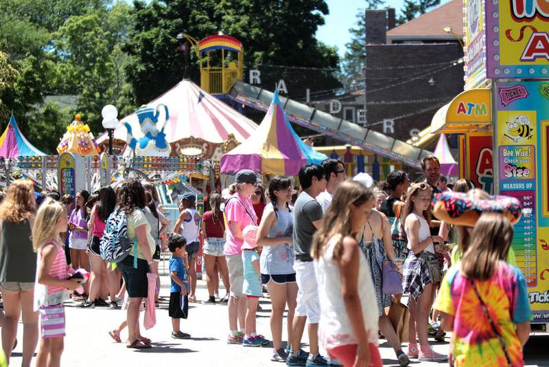 Patrons wait in line for the carnival rides during the first day of the annual Swedish Days Festival in Geneva June 21.