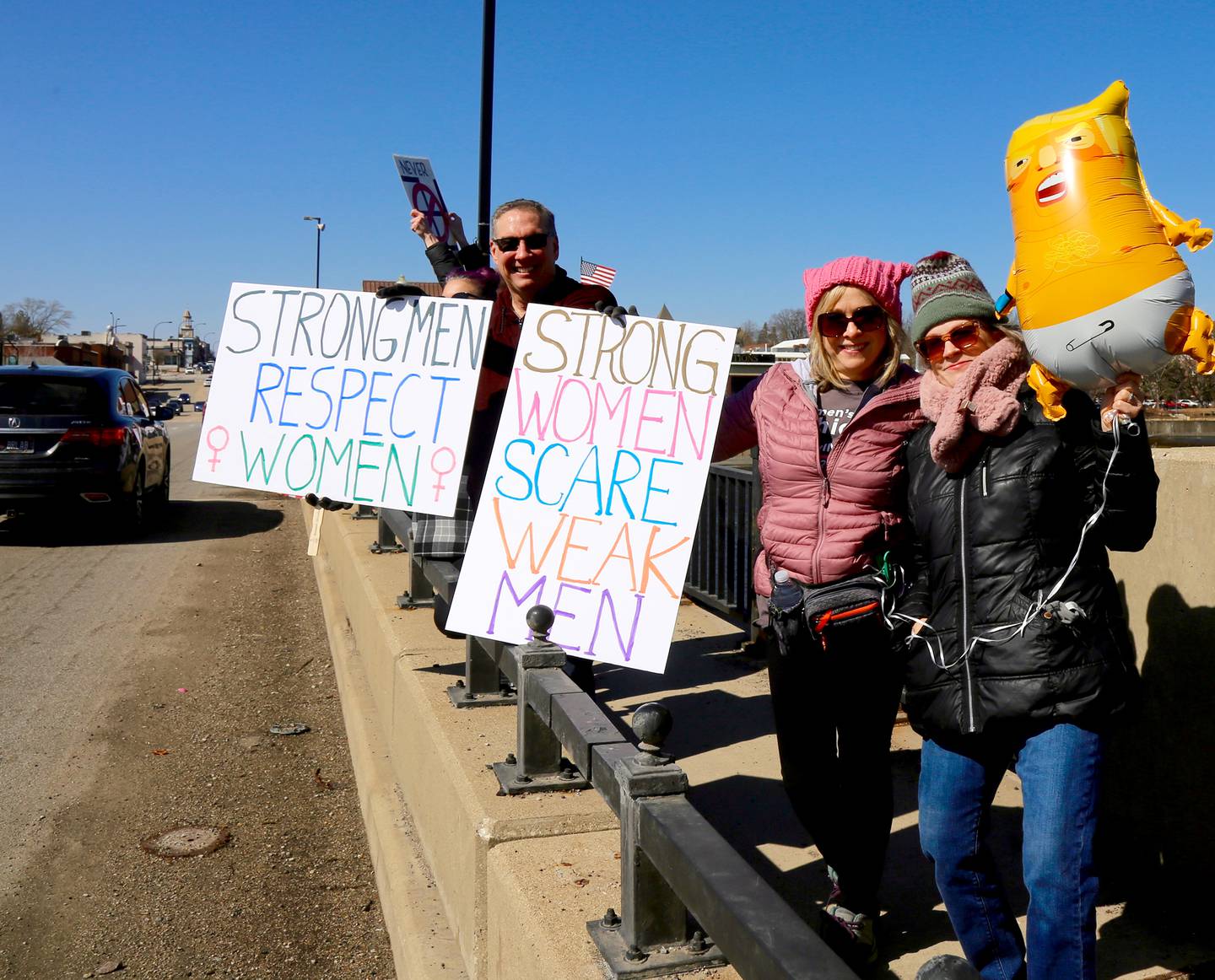 Hundreds of people – mostly women – filled the walkways across the Fox River on Illinois Route 38 in Geneva, spilling over to the sidewalks on either side on Saturday, March 8, 2025 in honor of International Women’s Day.