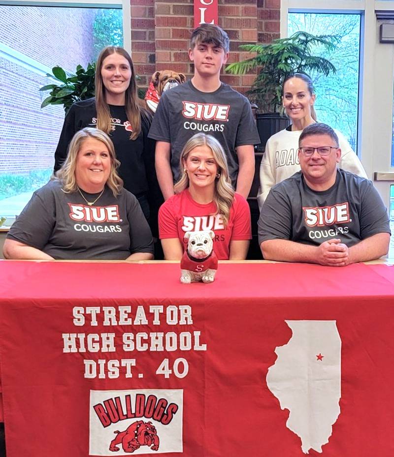 Recent Streator graduate Emma Devera – seated at center here between parents Megan and Jeremy Devera – has committed to continue her education at Southern Illinois University Edwardsville and her dance career at the National Dance Alliance Division I level with the SIUE Dance Team. Standing behind at her signing ceremony are dance coaches Ashley Manypenny (left) and Rachel Martin (right) along with Emma's brother, Eddie Devera.