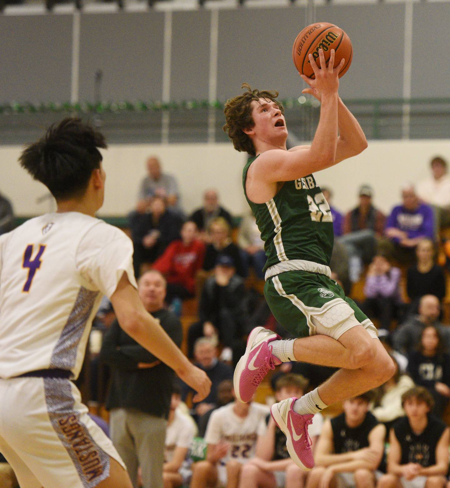 Glenbard West’s Bennett Schwanke drives to the basket against Rolling Meadows during the Jack Tosh Holiday Classic boys basketball tournament, played in Elmhurst on Tuesday, December 26, 2023.
