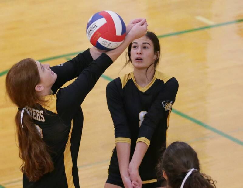 Putnam County's Maggie Spratt hits the ball as teammate Ava Hatton steps back in the Tri-County Conference Tournament on Monday, Oct. 10, 2022 in Seneca.