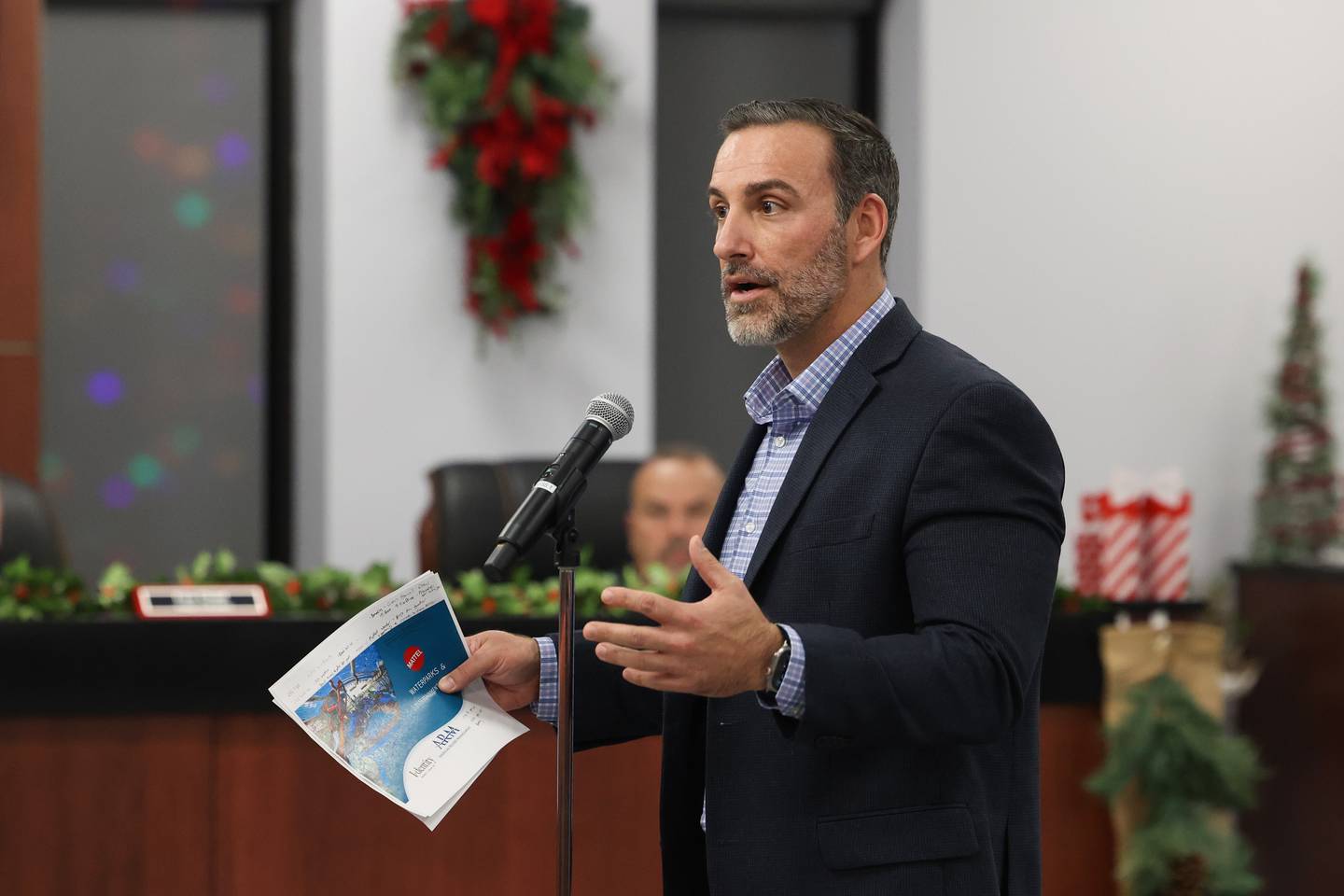 Justin Brown, Executive Vice President of Development with American Resort Management, speaks at the village Bradley board meeting on Monday, Dec. 8, 2025. American Resort Management and Mattel have partnered to create a new brand of indoor waterparks, Mattel Wonder. Bradley's waterpark wil be one of the first sites.