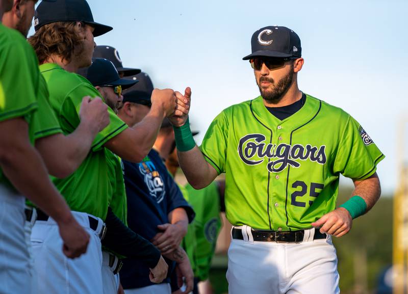 Sean King for the Daily Herald
Kane County Cougars third baseman Dylan Busby (25) greets his team members during opening day introductions at Northwestern Medicine Field in Geneva on Friday, May 13, 2022.