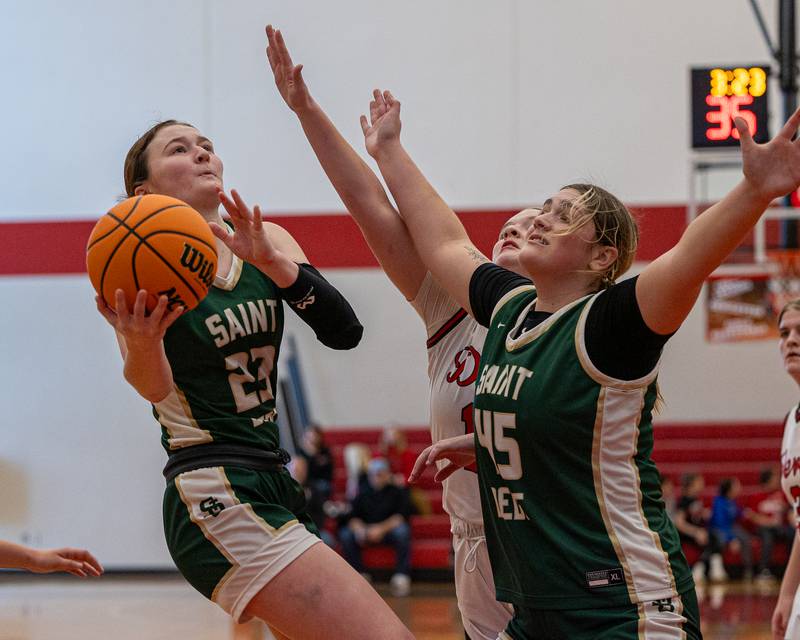 Lili McClain (23) of St. Bede leaps into layup as teammate Savannah Bray (45) Gortat screens Hall's defender on Saturday, January 31, 2026 at Hall High School in Spring Valley.