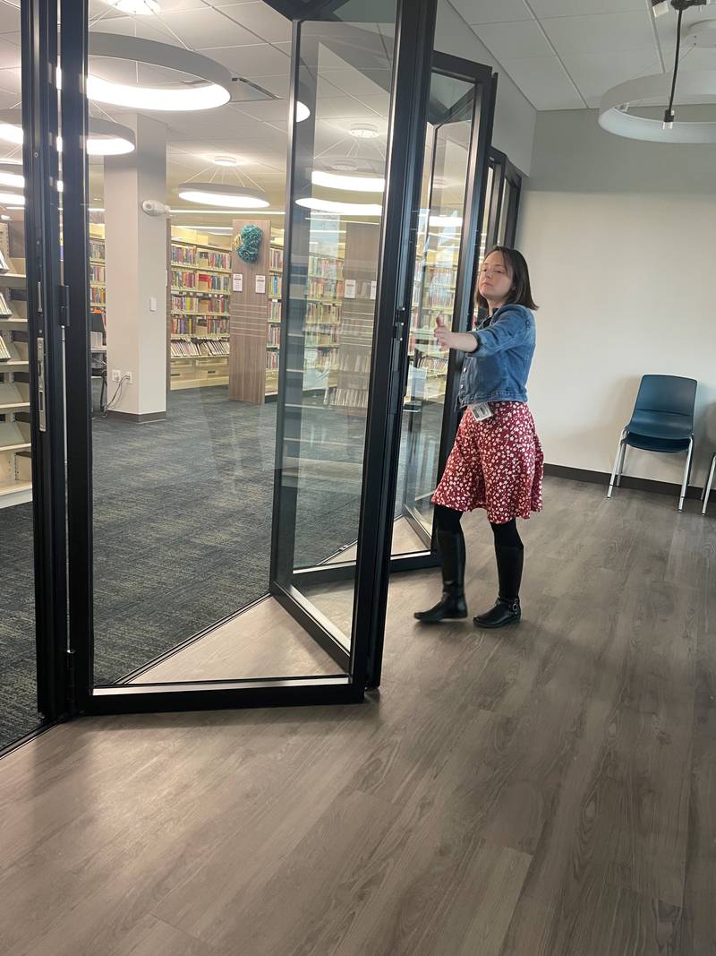 Algonquin Area Public Library's Eastgate Branch Manager Sam Chiappone opens sliding doors of the newly added FlexSpace. The space is designed to foster group gatherings such as book clubs, as well as host some smaller adult programming and crafts. The room includes a large activity area, storage, a sink, retractable outlets, a TV screen, and plenty of natural light with the newly added west-facing windows. It's part of a $6 million renovation of the branch, which reopened Jan. 6, 2025.