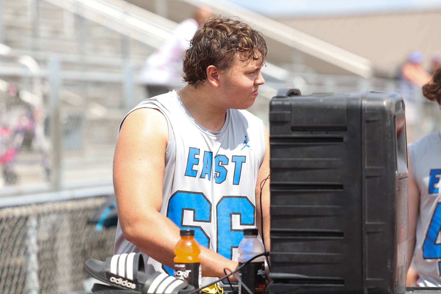 Lincoln-Way East center Josh Janowski works the music playlist during a 7-on-7 scrimmage at Lincoln-Way East on Tuesday, July 18th, 2023 in Frankfort.