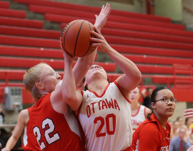 Ottawa's Kendall Lowery eyes the hoop as Streator's Mina James draws a foul during the Lady Pirate Holiday Tournament on Wednesday, Dec. 20, 2023 in Kingman Gym.
