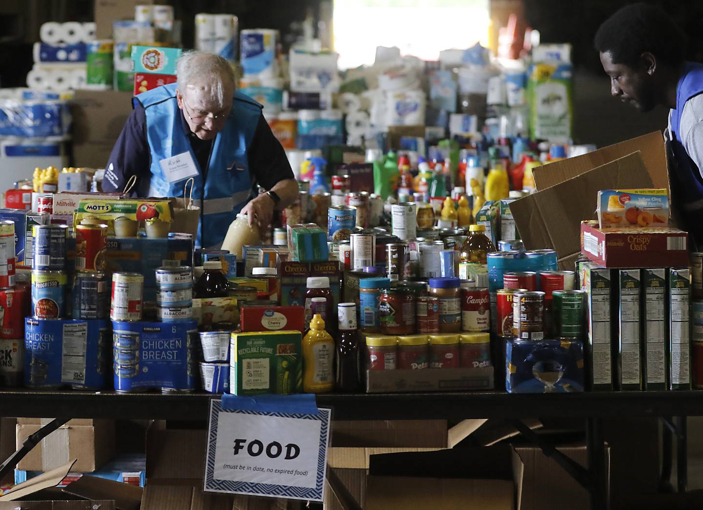 Russ Bartmess, a McHenry County Medical Reserve Corp volunteer, sorts items during the Operation Dropbox Exercise on Tuesday , June 11, 2024, at the McHenry County Division of Transportation near Woodstock. The training exercise simulates the process of unloading and distributing medical counter-measures during emergencies along with helping to sort and distribute the donated items to veterans and their families in the county.