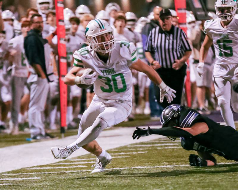 York's Jake Mellon avoids the defense enroute to a touchdown run during football game between York at Downers Grove North.  Sept 29, 2023.