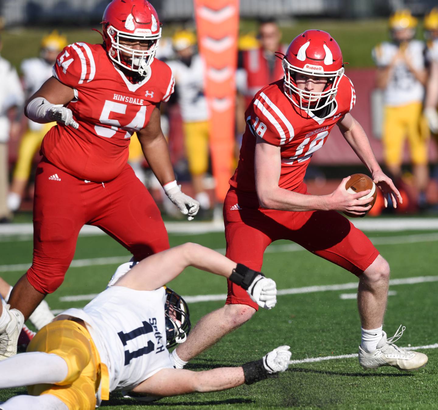 Hindale Central quarterback Billy Cernugel, right, avoids an attempted sack by Glenbrook South's Jacque Gasriepy during the second round of the Class 8A high school football playoffs in Hinsdale Saturday. Hinsdale Central 54 is Josh Narcisse.