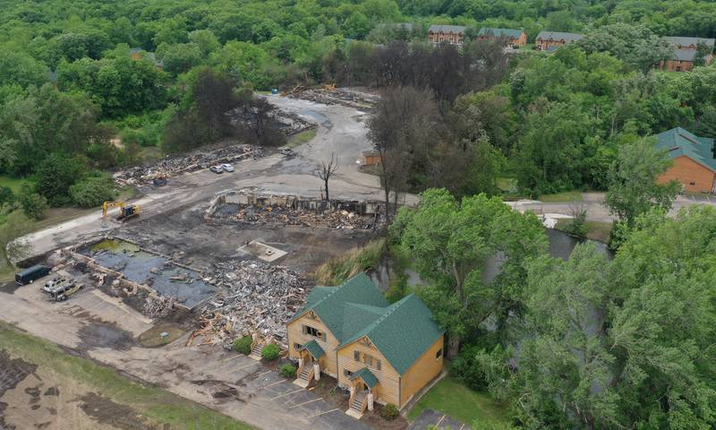 The foundations of three sets of cabins, dead trees, and burnt vehicles are all that remains after a major fire swept through the Grand Bear Resort and set fire to 28 cabins on Tuesday, May 31, 2022 in Utica.