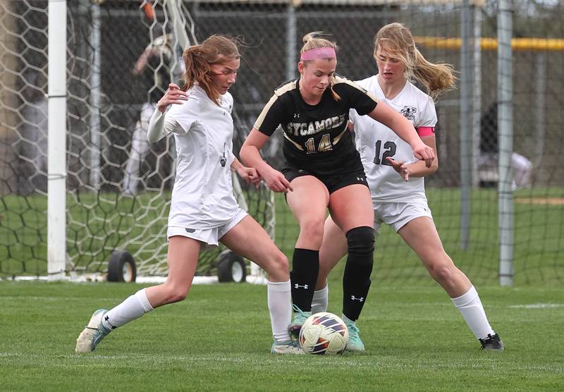 Sycamore's Peyton Wright tries to get between Kaneland's Zoe Gannon (left) and Casey O'Brien during their game Wednesday, April 17, 2024, at Sycamore High School.