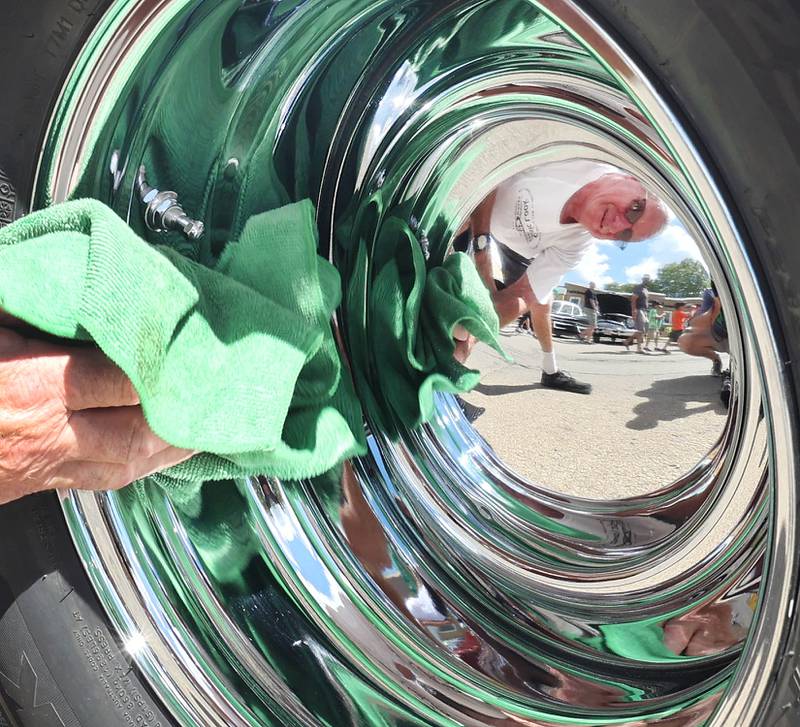 Mark Anning, from Tonica, shines the hubcaps on his 1959 Chevy Apache truck Sunday, July 31, 2022, during the 22nd Annual Fizz Ehrler Memorial Car Show in Sycamore.