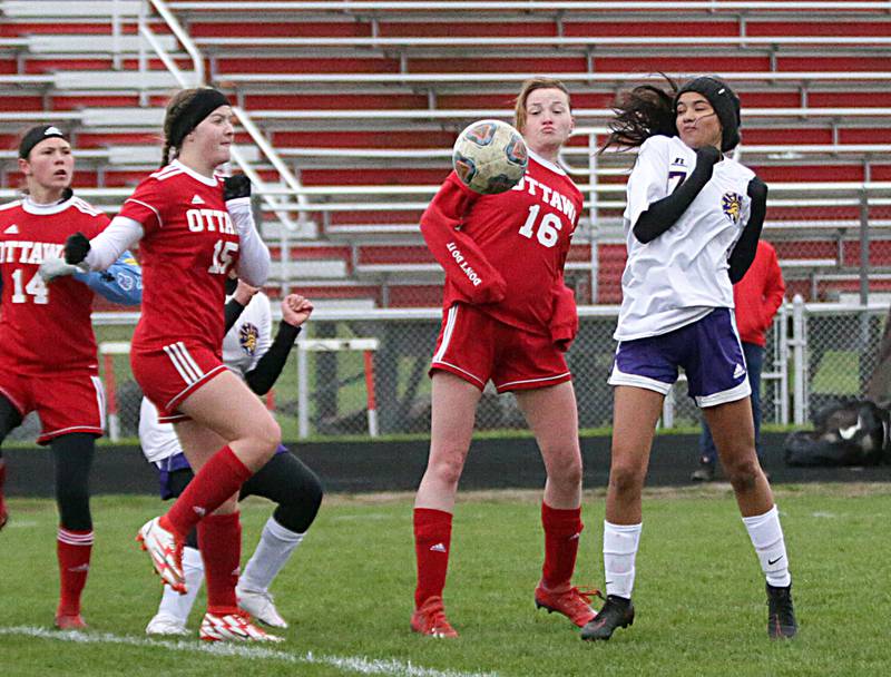 Ottawa's Paris Blankenship (16) deflects the ball away from Mendota's Crystal Garcia (7) on Monday, April 18, 2022, in Ottawa. The teams tied.