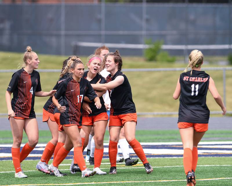 St. Charles East Taum Smith, center, celebrates with teammates after scoring a goal in the overtime portion of the sectional title game on Saturday May 27th while taking on St. Charles North held at West Chicago Community High School.