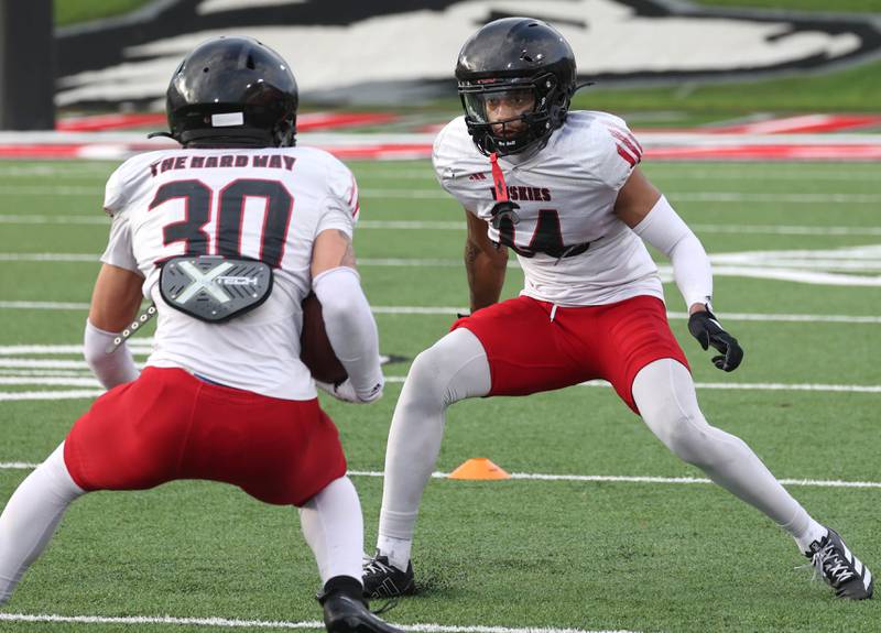 Northern Illinois University safety Malik Armstrong (right) looks to make a tackle Tuesday, April 14, 2026, during a drill at spring practice in Huskie Stadium at NIU in DeKalb.