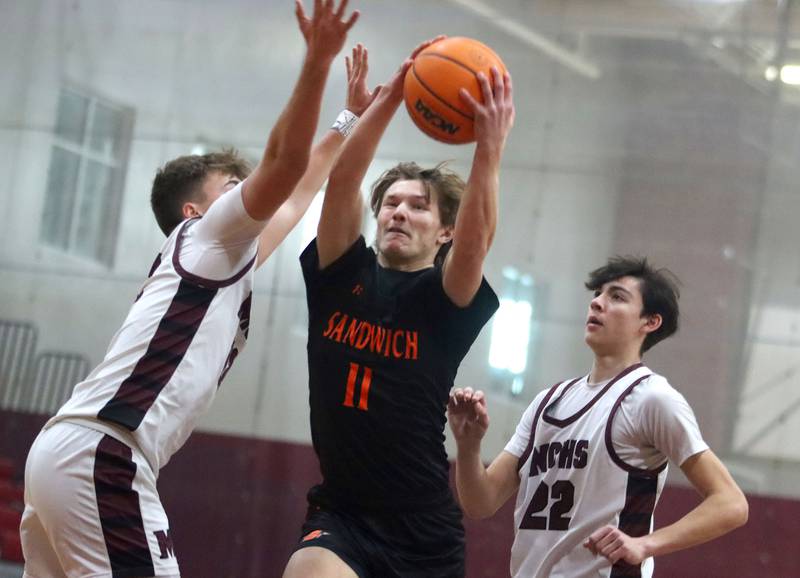 Sandwich’s Nicholas Michalek works under the net in varsity boys basketball action on Saturday, Jan..24, 2025, at Marengo High School in Marengo.