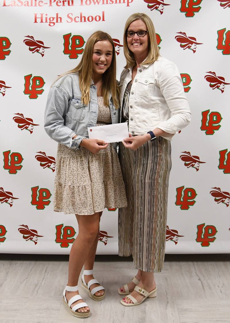 Emma Garretson (left) received the City Center Physical Therapy Scholarship, presented by Gina Martin (right). The $1,000 scholarship is awarded to a student pursuing a career in physical therapy or sports medicine.