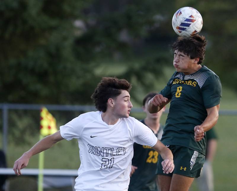 Crystal Lake South's Hayden Stone heads the ball away from Huntley's Anthony Aweve during a Fox Valley Conference soccer match on Thursday, Sept. 28, 2023, at Crystal Lake South High School.