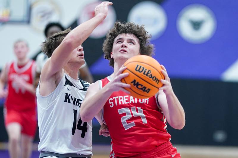 Streator's Jacob Hagie (24) plays the ball in the post against Kaneland’s Preston Popovich (14) during a semi-final basketball game in the 61st annual Plano Christmas Classic at Plano High School on Friday, December 27, 2024.