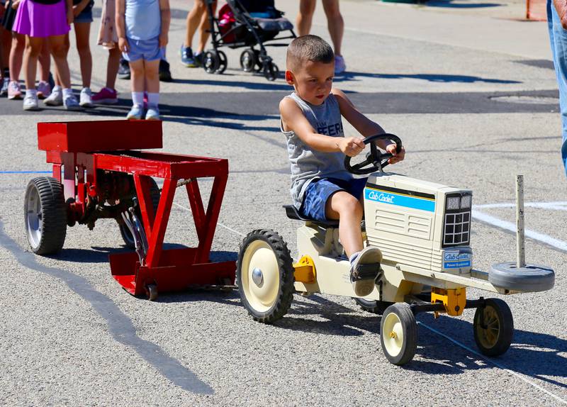 Owen Dixon, 5, pedals a tractor in the Kids Pedal Tractor Pull at the Maple Park Fun Fest on Saturday, Aug. 31, 2024 in Maple Park.