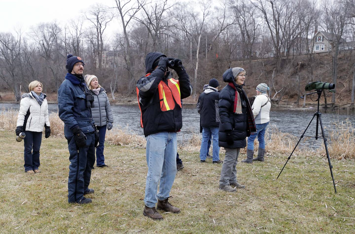 People watch a group of about 30 Golden Eye Ducks on the Fox River as they gather at Cornish Park for the “In Search of Eagles” program Saturday January 21, 2023 in Algonquin. Two immature eagles were seen early in the morning flying up and down the river south of the dam.