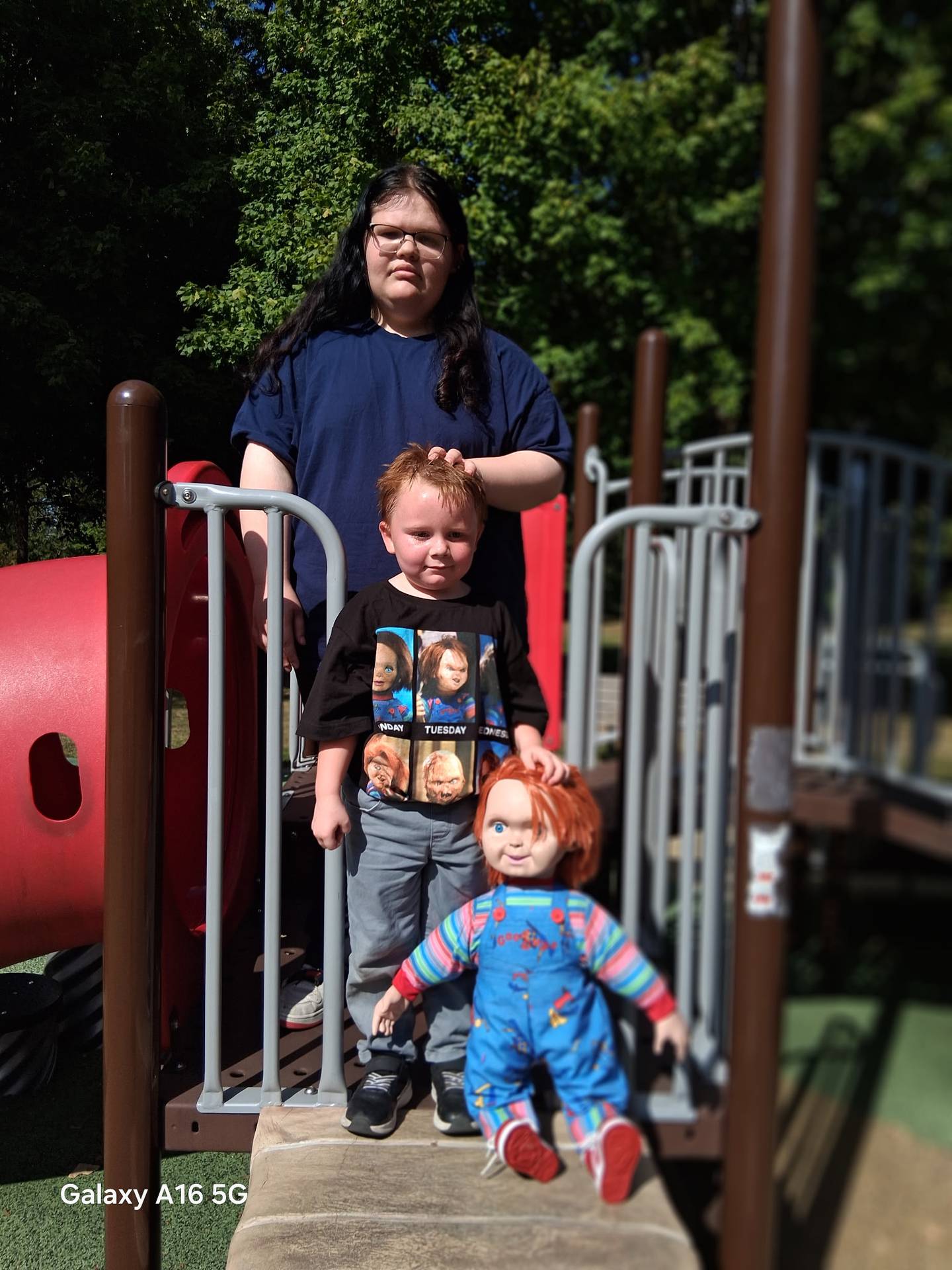 Faith McCarthy poses with her brother, Noah, and Chucky.