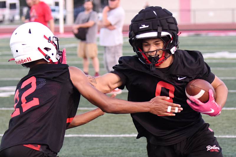 Bradley-Bourbonnais' Omari Taylor, right, attempts to stiff arm a defender at practice Monday, Aug. 11, 2025.