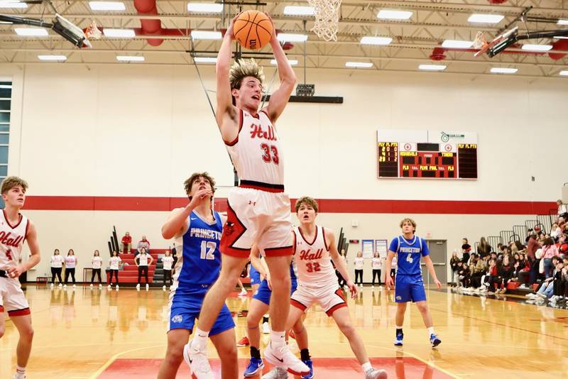 Hall's Braden Curran pulls down a rebound against Princeton Friday night at Hall High School. The Red Devils won 62-54.