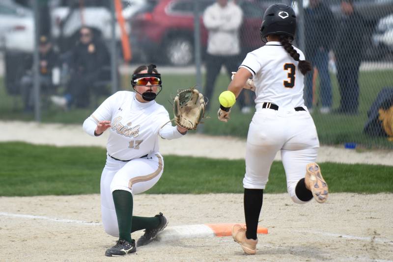 Bishop McNamara's Gabby Burnett, left, fields a throw at first base as St. Laurence's Viviana Chavez legs out an infield hit during a game at Bishop McNamara Saturday, April 11, 2026.