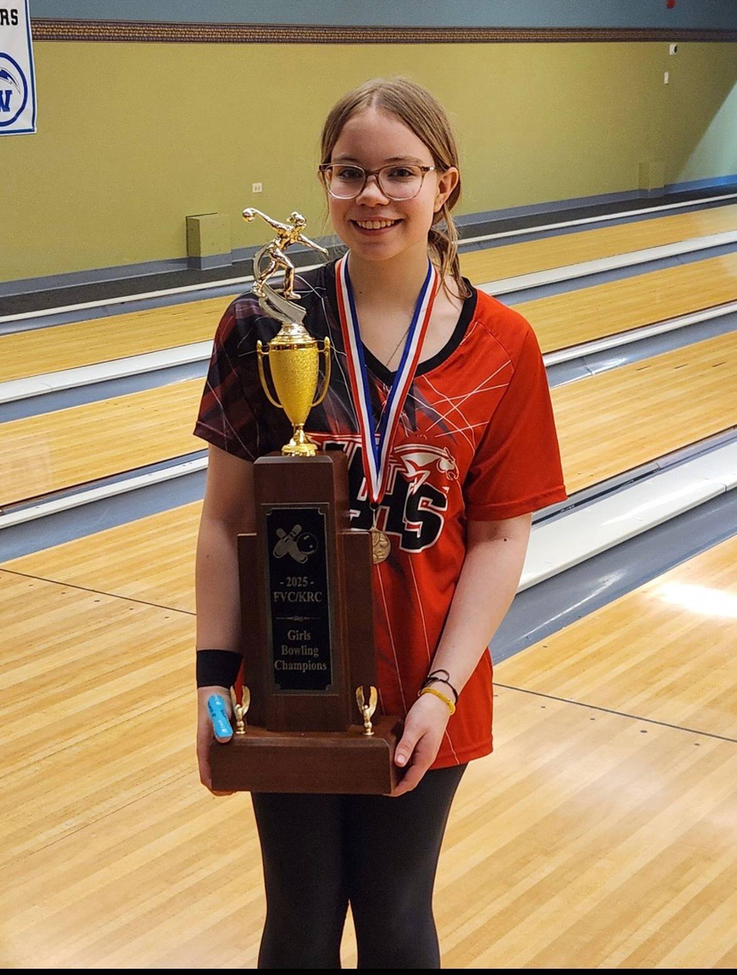 Huntley senior Erica DeBello poses with the Fox Valley/Kishwaukee River Conference championship trophy.