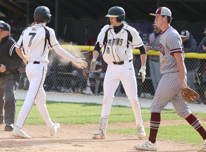 Sycamore's Alex VanMastrigt (left) is congratulated after scoring a run by teammate Jackson MacDonald Wednesday, May 13, 2026, during their game against Morris at the Sycamore Community Sports Complex.