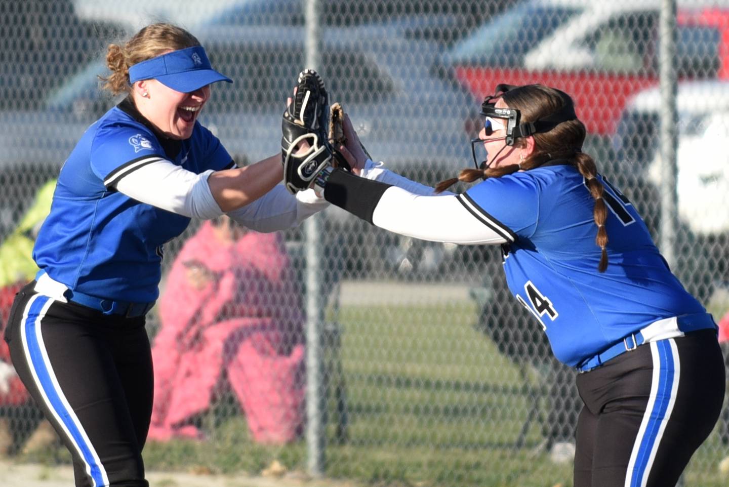 Peotone's Megan Cadieux, left, is congratulated by Abigail Christenberry after making a catch during a game at Bishop McNamara Monday, March 23, 2026.
