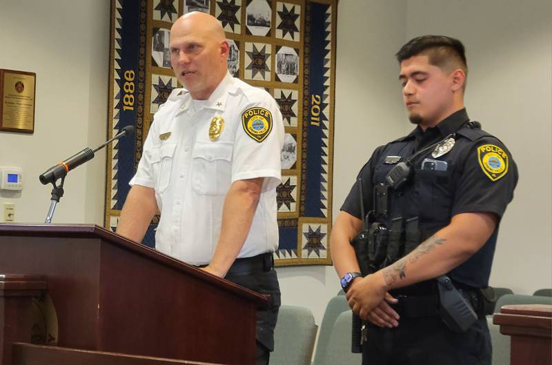 Spring Valley Police Chief Adam Curran (left) introduces his newest officer, Ralphie Romo, to the Spring Valley City Council on Monday night.