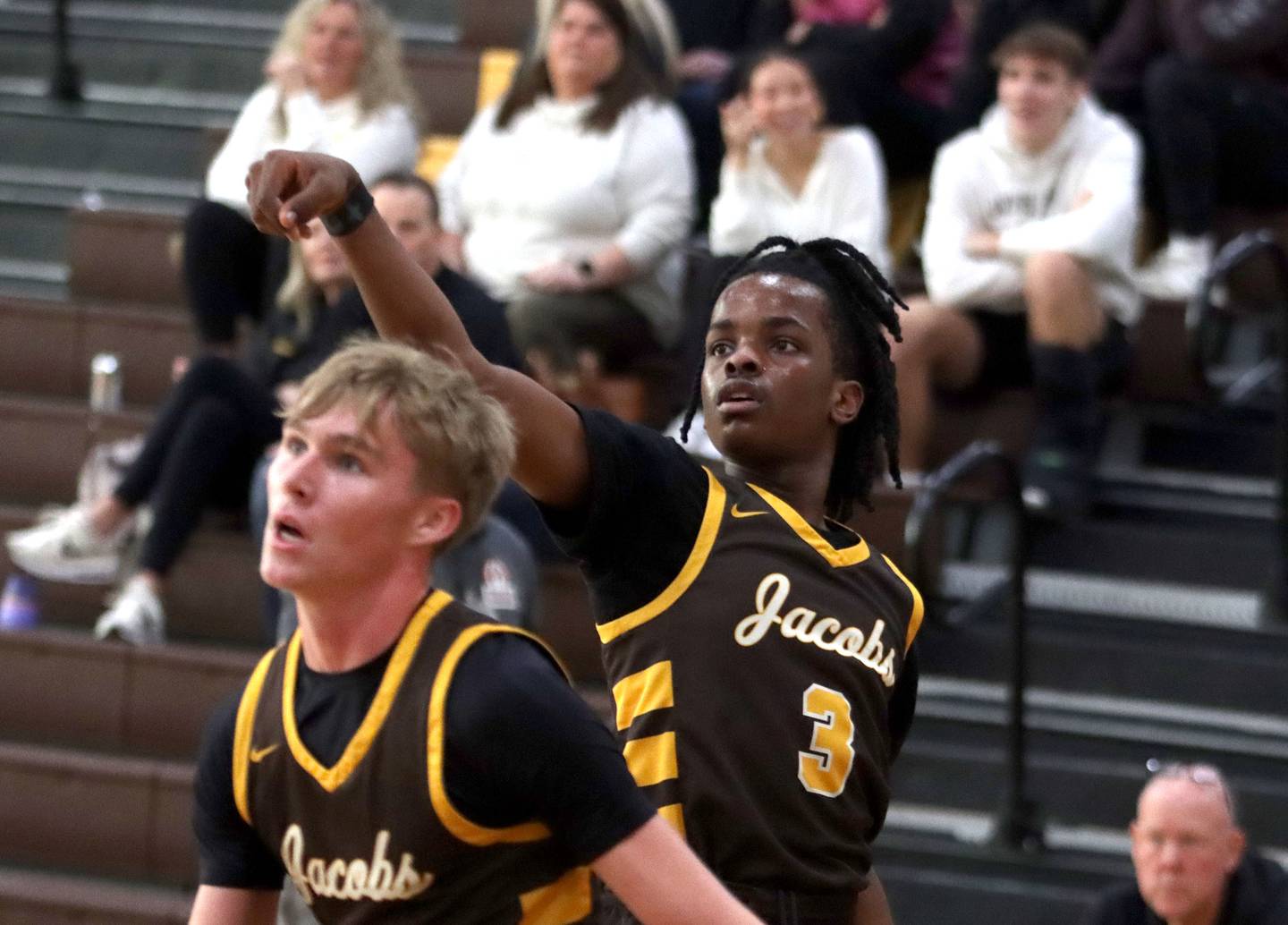 Jacobs’ Malachi Bell, back puts the finishing touch on an outside shot against Grayslake Central in varsity boys basketball Hinkle Holiday Classic action on Tuesday, Dec. 23, 2025, at Jacobs High School in Algonquin.