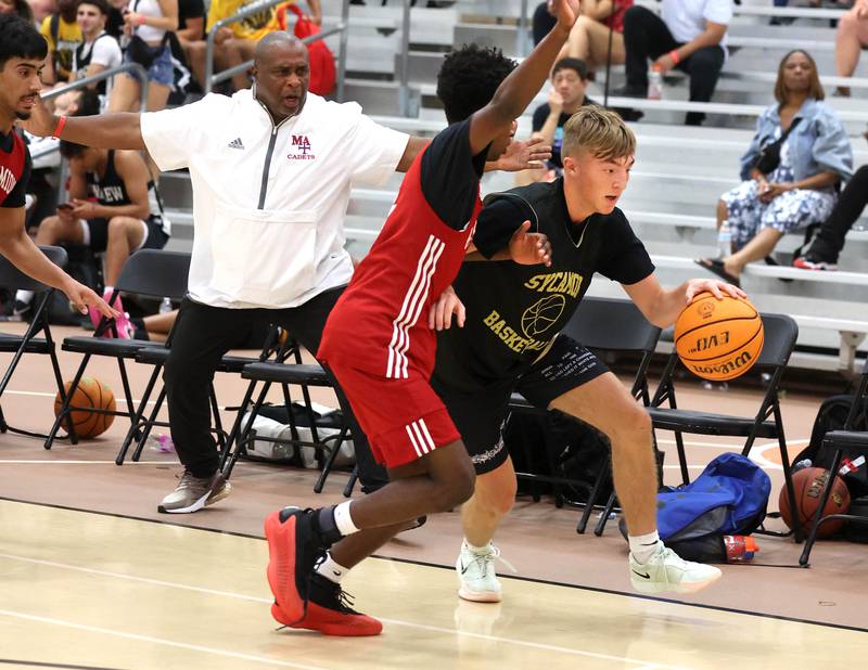 Sycamore’s Xander Lewis goes baseline against a defender Friday, June 20, 2025, during their game against Marmion in the DeKalb Live summer tournament at DeKalb High School.