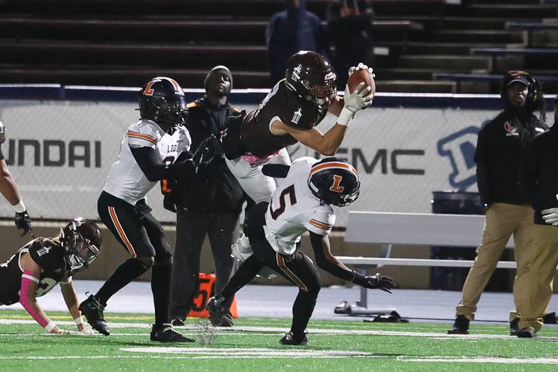 Joliet Catholic’s Zak Beitler comes down with the interception against Leo on Friday, Oct. 6, 2023 in Joliet.