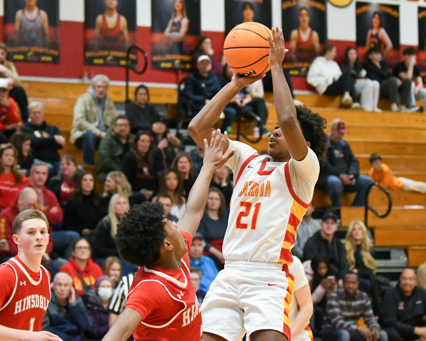 Batavia's Xavier Justice (21) makes a shot during the game on Saturday Jan. 24, 2026, while being defended by Hinsdale Central's RJ Lewis (2) held at Batavia High School.